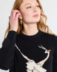 model wearing a black sweater with a animal ballet design on a white background