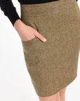 Close-up of the pocket and flecked herringbone texture of the Meg Mini Skirt, photographed against a plain white studio background.