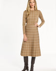 A woman modeling the chestnut side of the Windowpane Plaid Reversible Flared Skirt with the matching crewneck, front view, photographed against a plain white studio background.