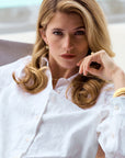 Woman in a white shirt with a neutral background