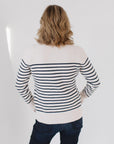 Back view of Eleanor Leftwich wearing The Perfect Striped Cardigan in cream with navy mariner stripes, paired with dark jeans.