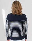 Back view of EL wearing the Perfect Striped Crewneck in navy with cream mariner stripes, paired with white jeans against a white background.