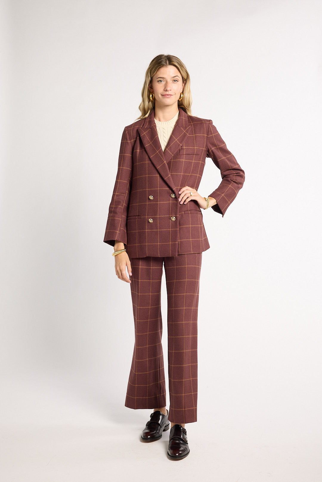 Woman wearing a burgundy blazer in a studio