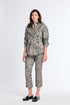Woman wearing a patterned outfit on a white background