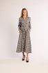 Woman wearing a plaid dress on a white background