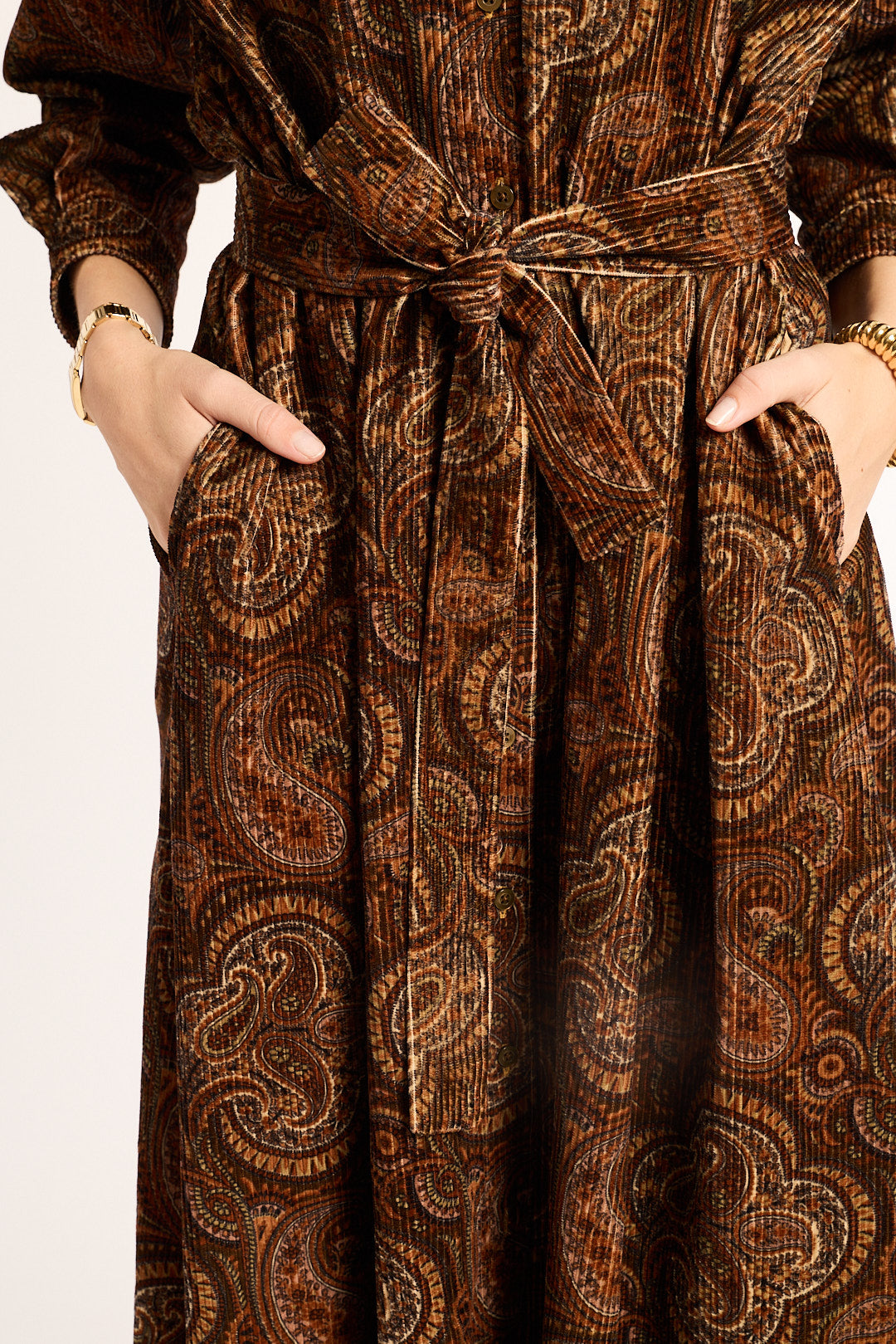 Brown patterned dress with a belt on a white background