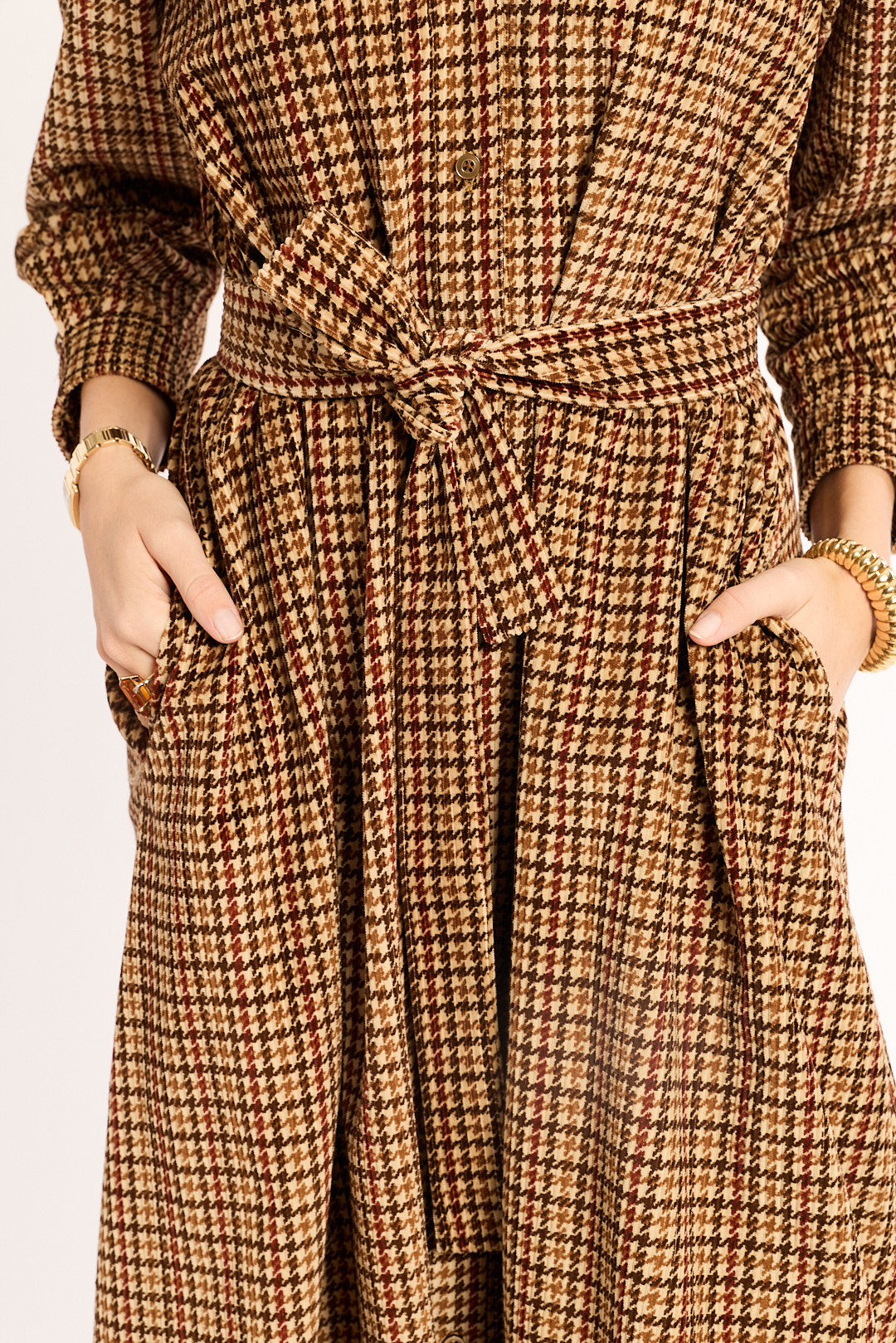 Brown checkered dress with a tie waist on a plain background