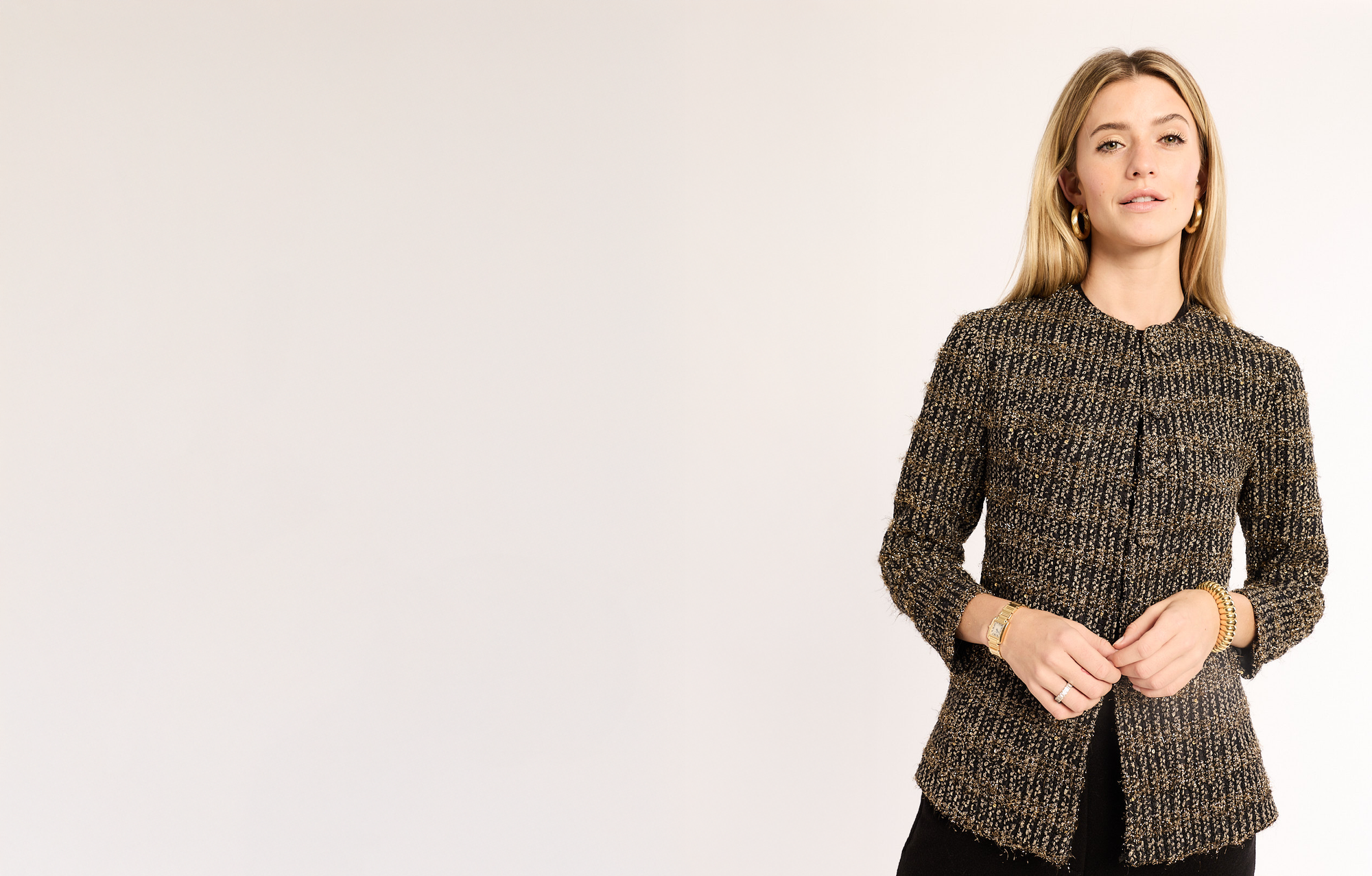 Woman wearing a textured brown jacket on a white background