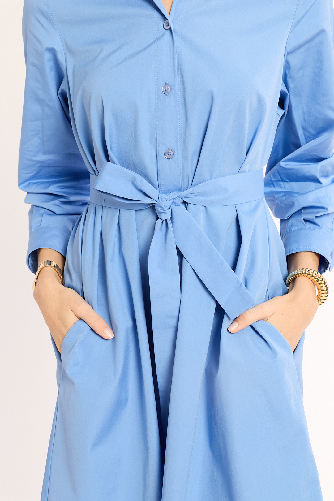 Light blue dress with a tie waist on a plain background