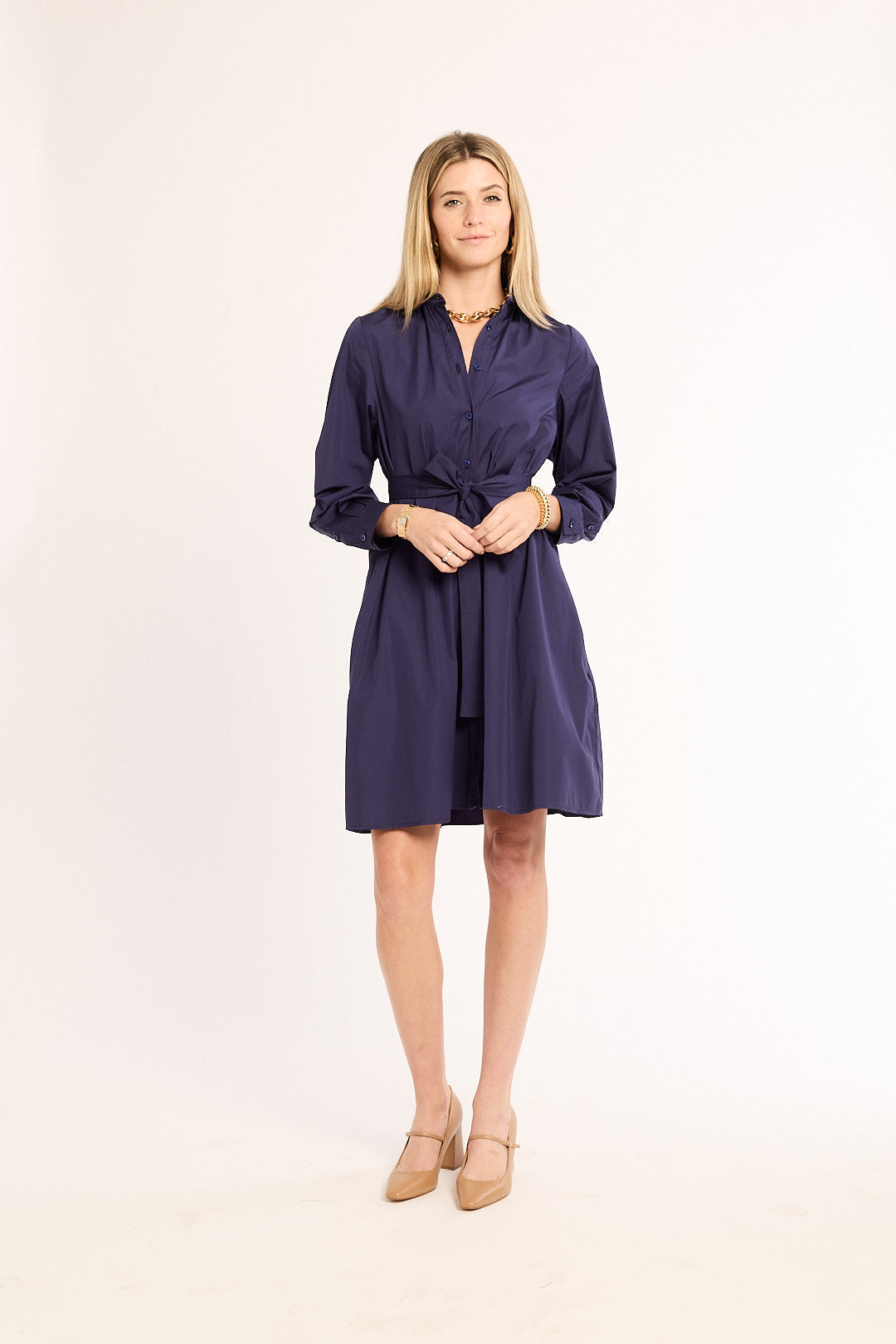 Woman wearing a navy blue dress on a white background