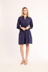Woman wearing a navy blue dress on a white background
