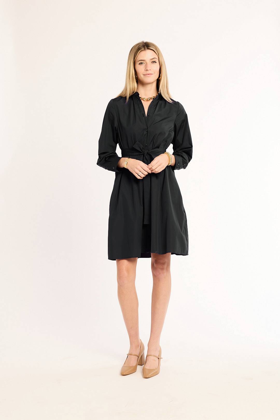 Woman wearing a black dress on a white background