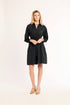 Woman wearing a black dress on a white background