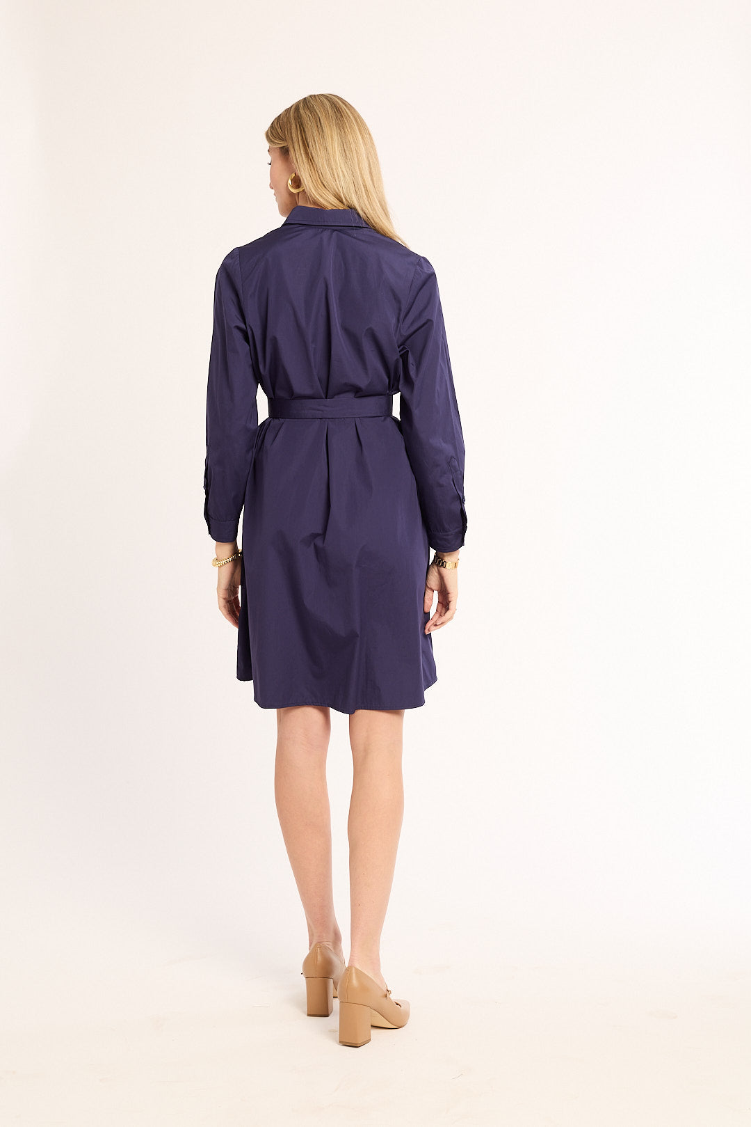 Woman wearing a purple trench coat on a white background