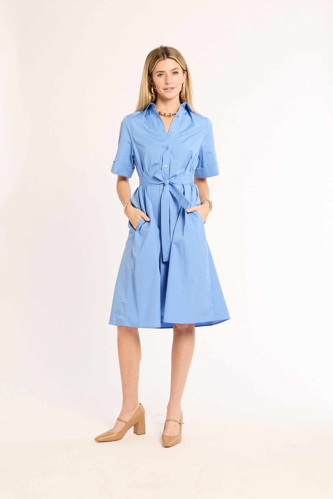 Woman wearing a light blue dress on a white background