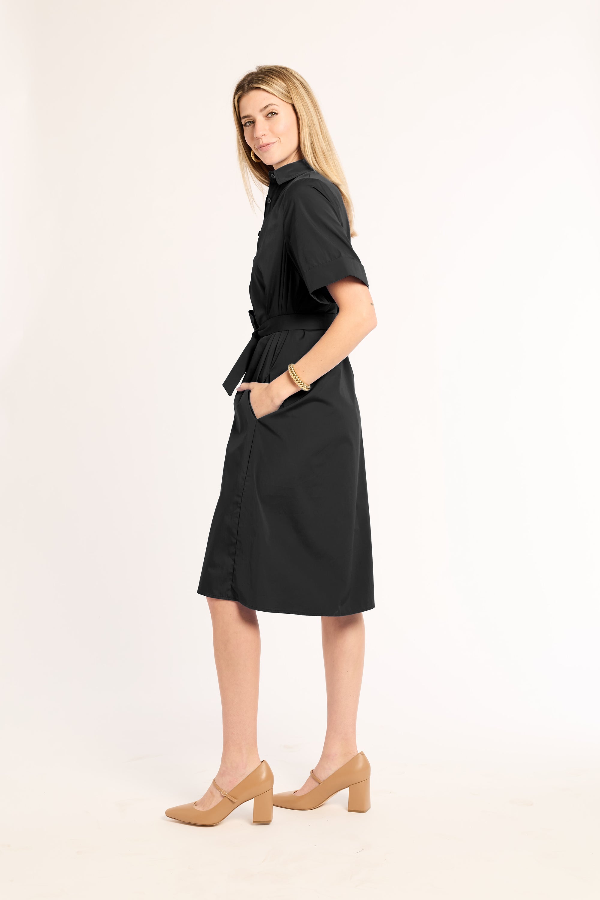 Woman wearing a black dress with a white background