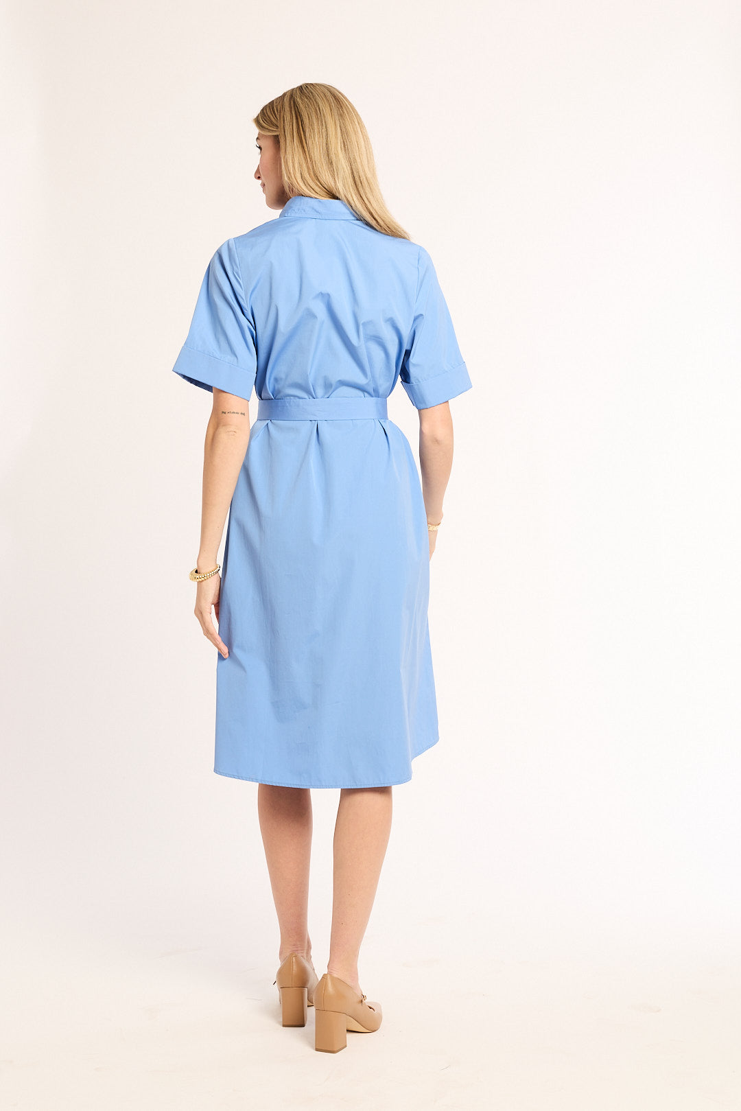 Woman wearing a light blue dress on a white background