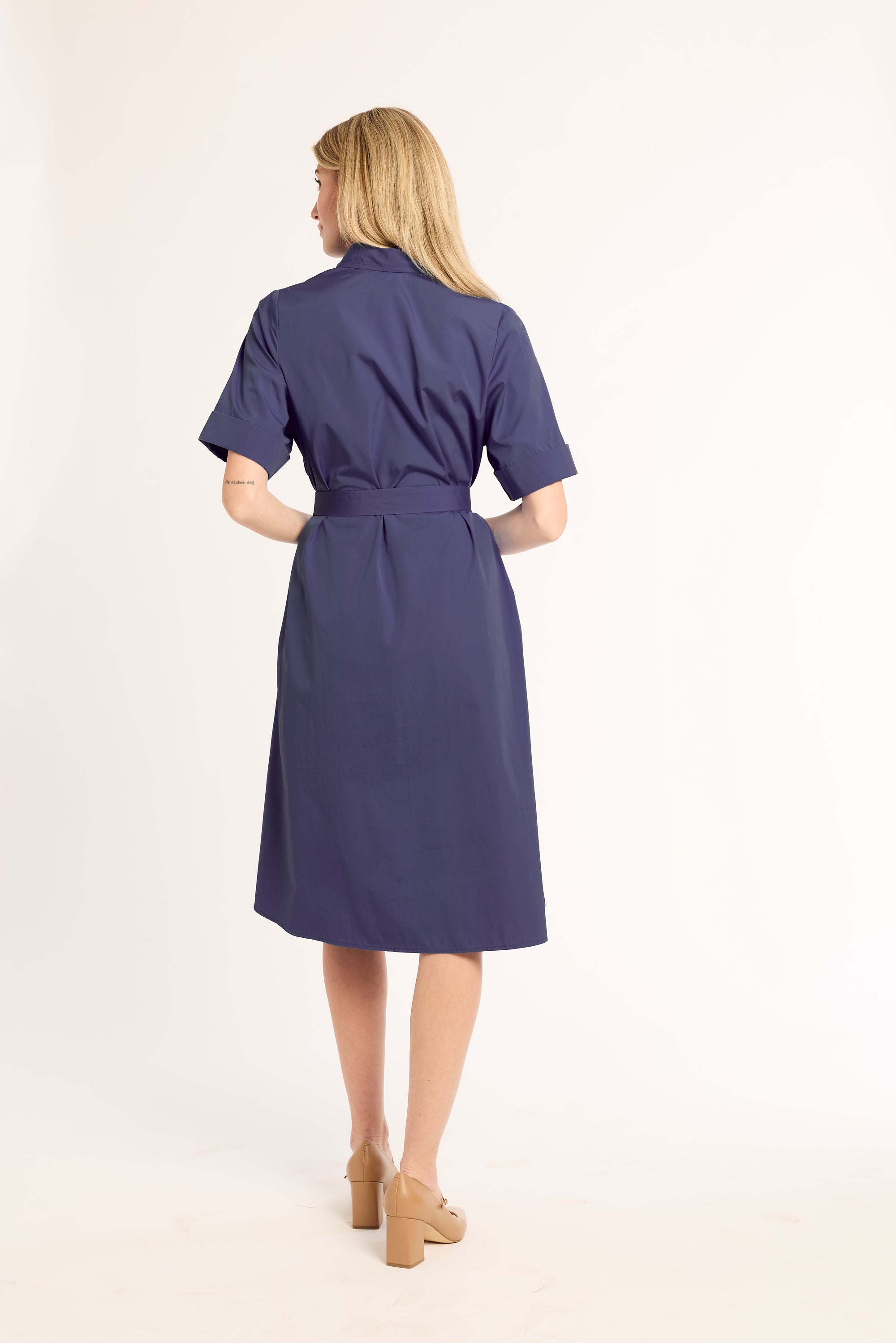 Woman wearing a blue dress on a white background