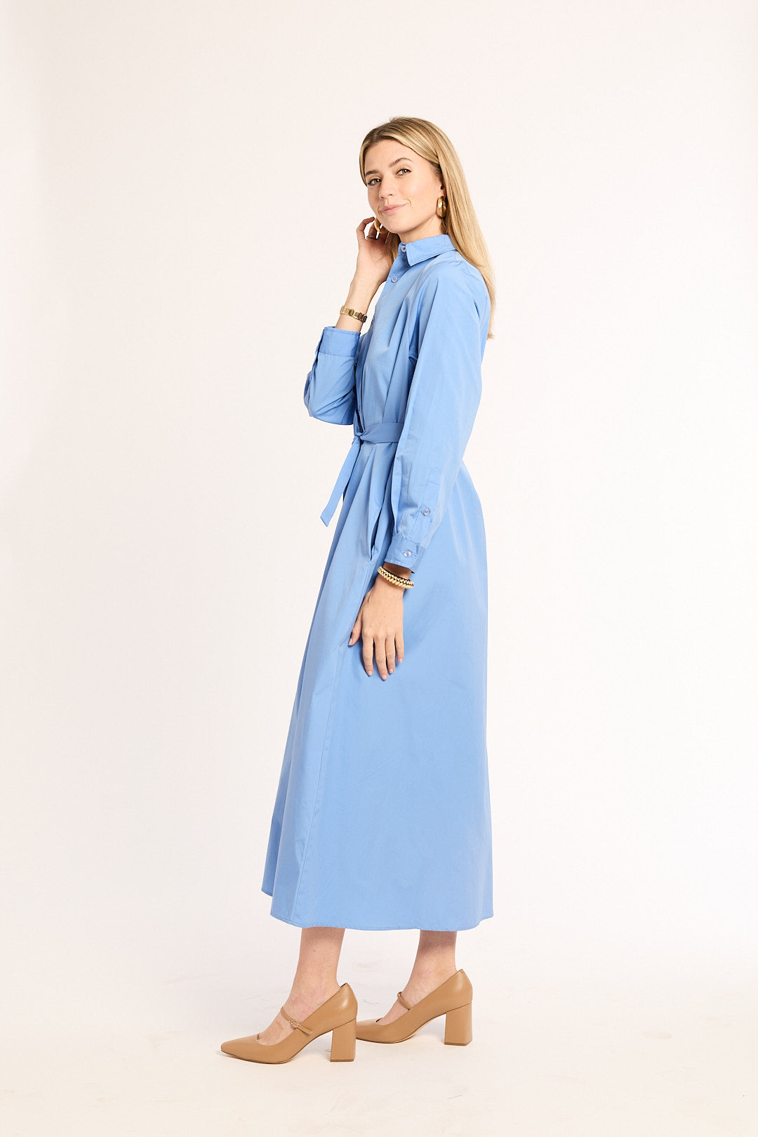 Woman wearing a light blue dress on a white background