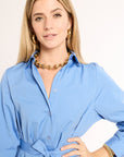 Woman wearing a blue dress with a white background