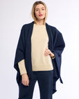 Woman wearing navy cashmere poncho.