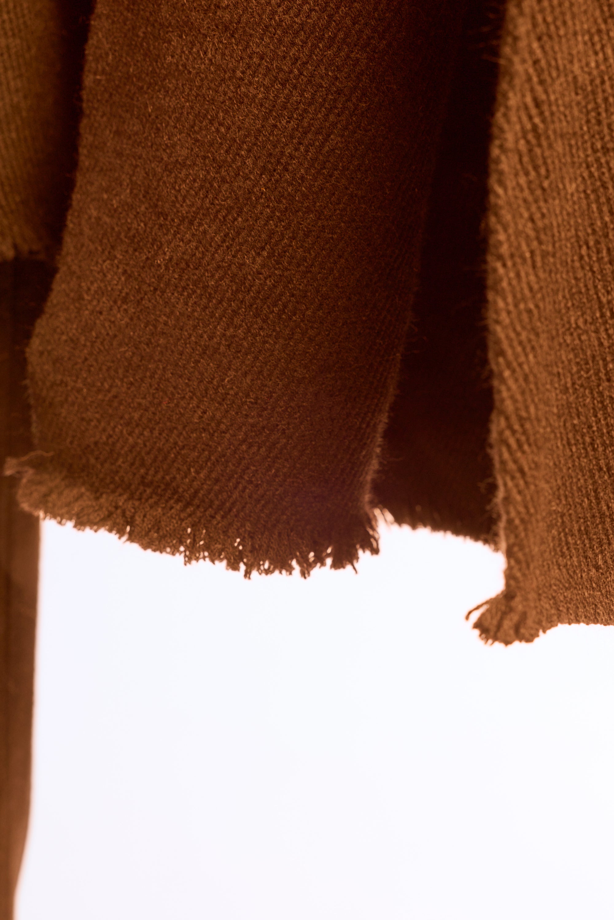 Close-up of a brown textured fabric with a white background