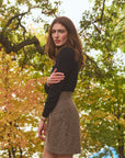 Woman wearing a mini tweed skirt outside