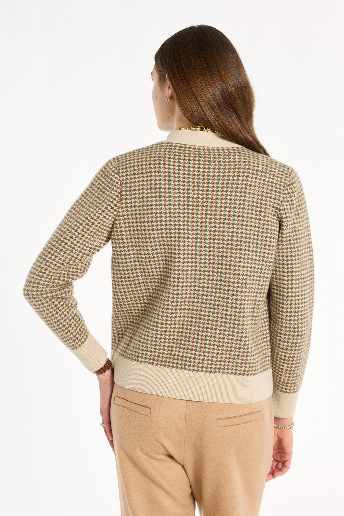 A woman modeling the Camel Tri-Color Check Classic Cashmere Cardigan with camel trousers, back view, photographed against a plain white studio background.