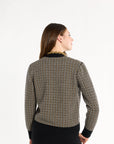 A woman modeling the Black Tri-Color Check Classic Cashmere Cardigan with black trousers, back view, photographed against a plain white studio background.
