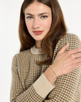 Close-up of the cream crew neckline and multicolor check pattern of the Camel Tri-Color Check Classic Cashmere Crew, photographed against a plain white studio background.