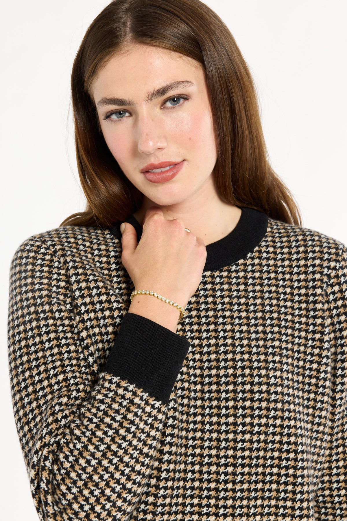 Close-up of the black crew neckline, cuff, and check pattern of the Black Tri-Color Check Classic Cashmere Crew, photographed against a plain white studio background.