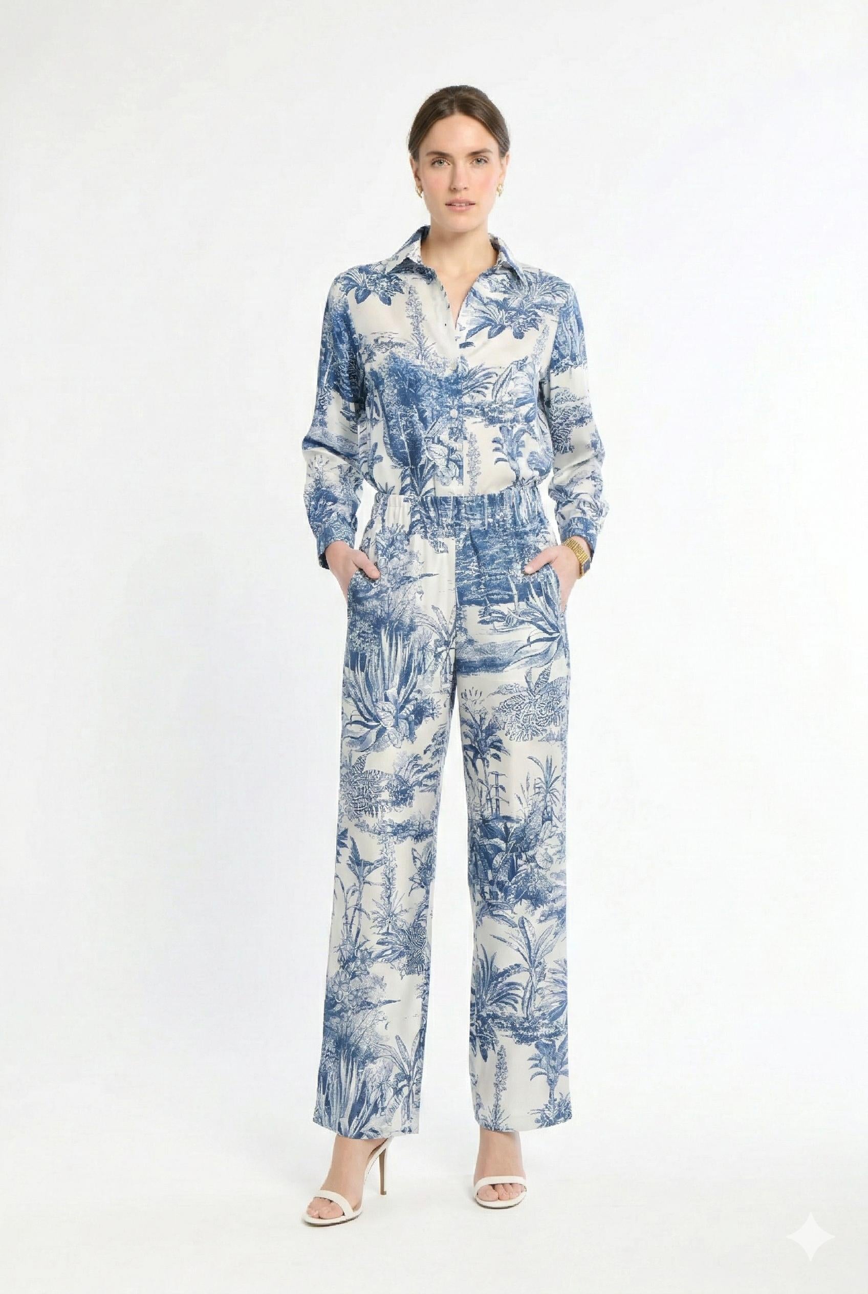 Woman wearing white and navy matching set on a white background