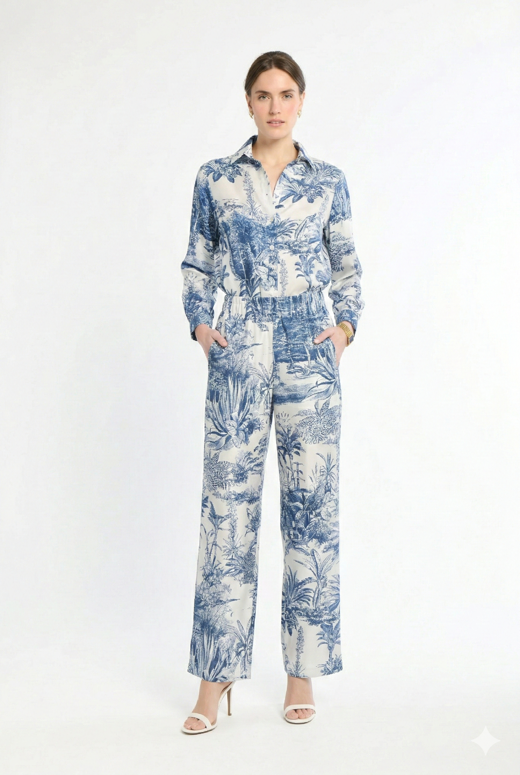 Woman wearing white and navy matching set on a white background