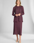 Woman modeling a pleated purple cardigan on a white backdrop