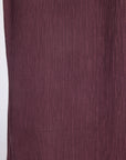 Close-up of a textured, vertically pleated fabric in purple color.