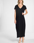 Woman modeling a v-neck silk pleated dress on a white background