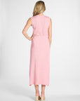 Woman modeling a light pink pleated skirt and shell on a white background