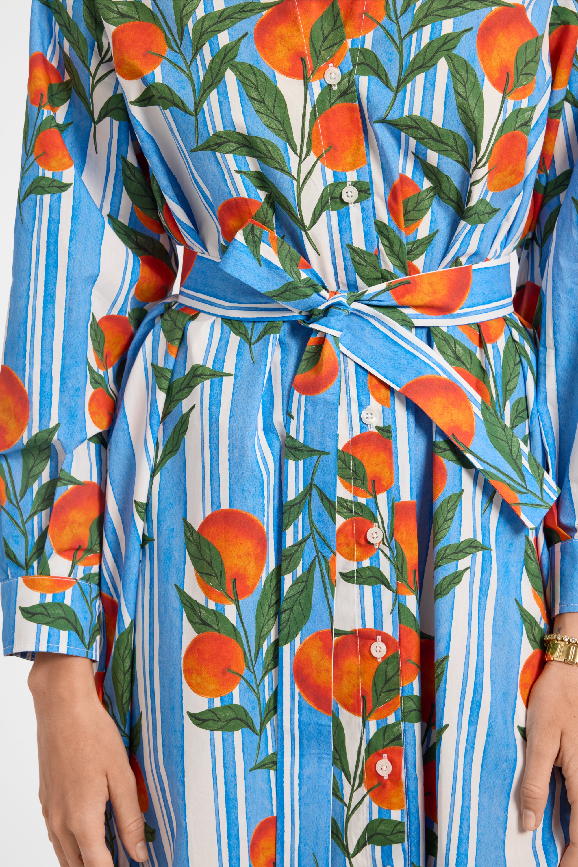Dress with oranges and striped pattern on a plain background