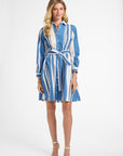 Woman wearing a blue and white striped dress on a white background