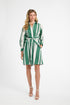 Woman wearing a green and white striped dress on a white background
