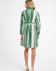 Woman wearing a green and white striped dress on a white background