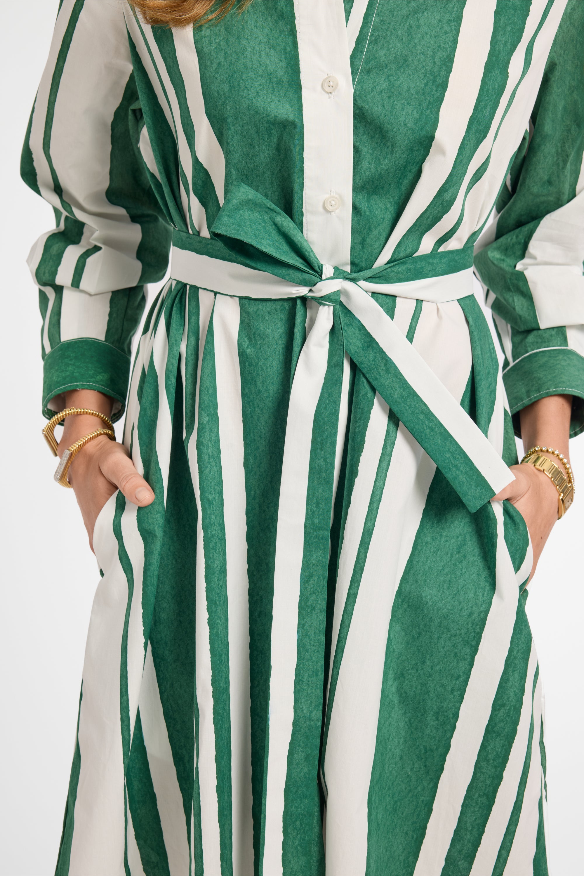 Green and white striped dress with a belt on a white background