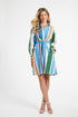 Woman wearing a colorful striped dress on a white background