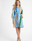 Woman wearing a colorful striped dress on a white background