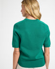 Woman wearing a green sweater on a white background