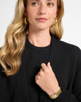 Woman wearing a black cardigan with a plain background
