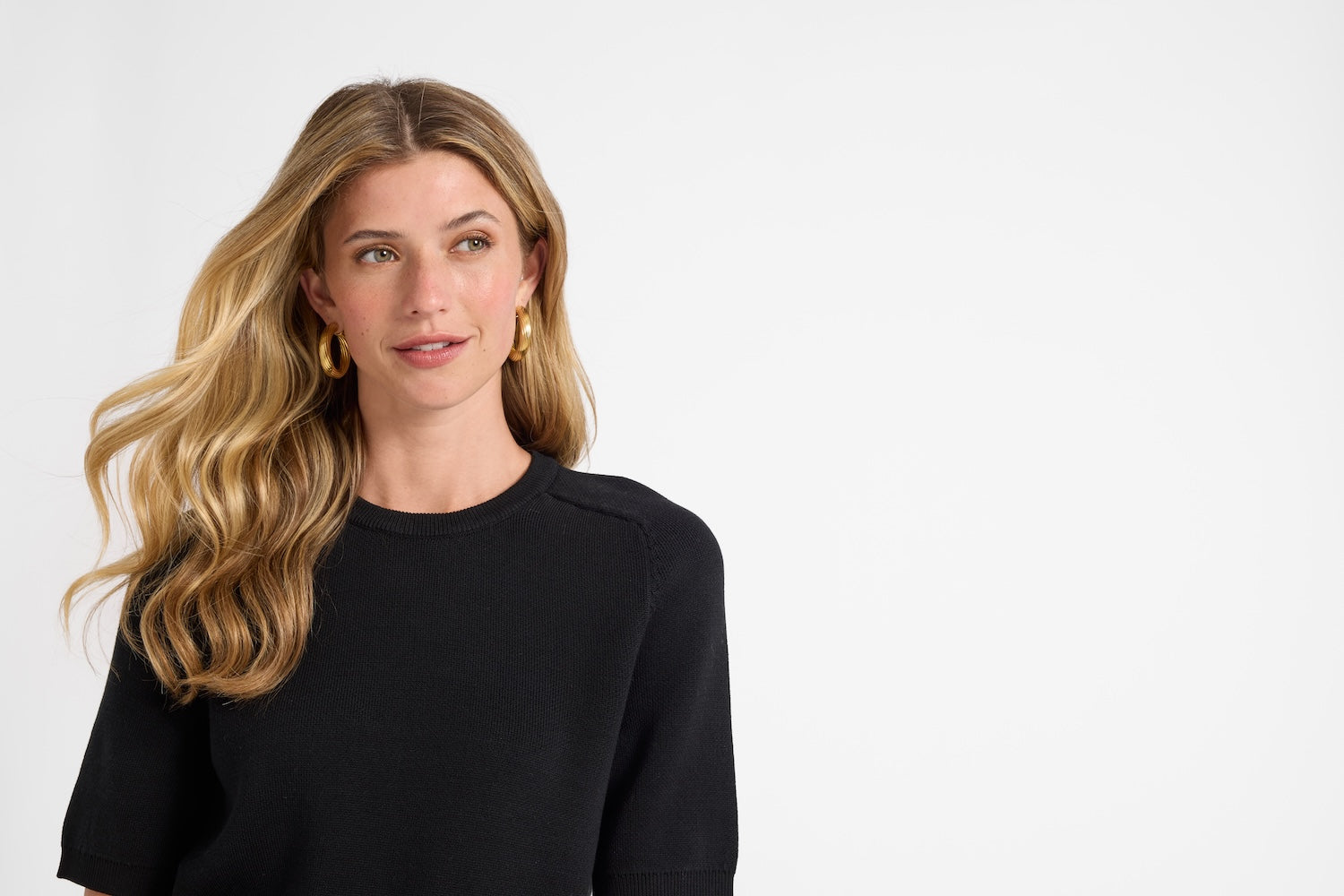 Woman wearing a black top against a white background