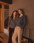 Women in a basement modeling cotton tops 