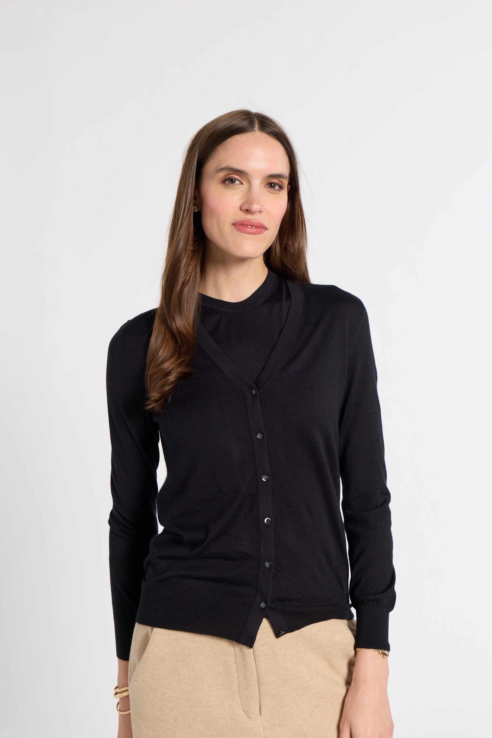 Woman modeling a black tissue cardigan on a white background