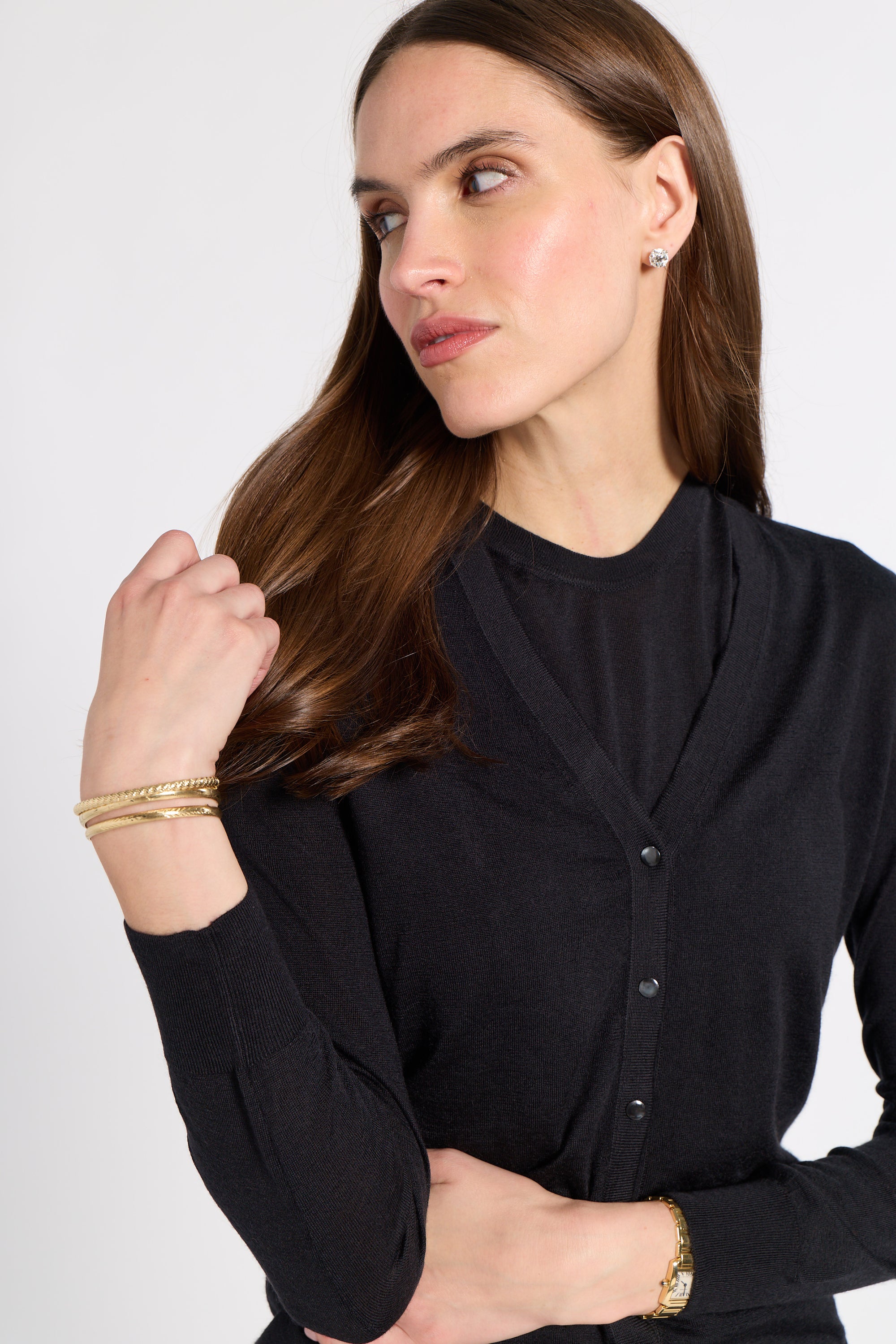 Woman modeling a black tissue cardigan on a white background